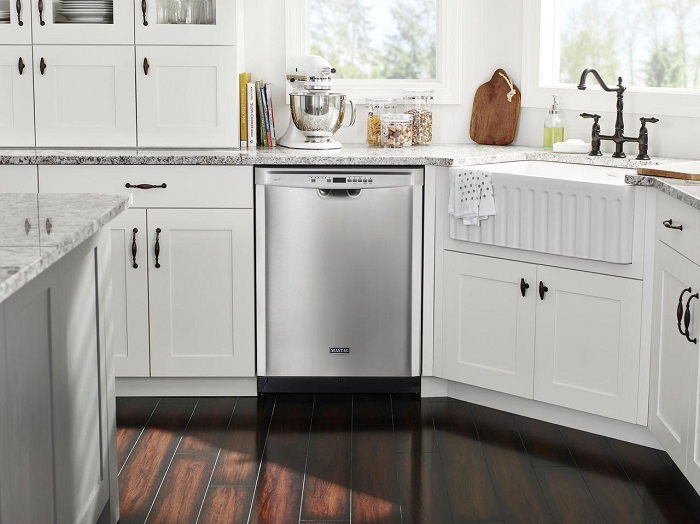 Modern kitchen granite countertop outfitted with a built in stainless steel Maytag dishwasher.