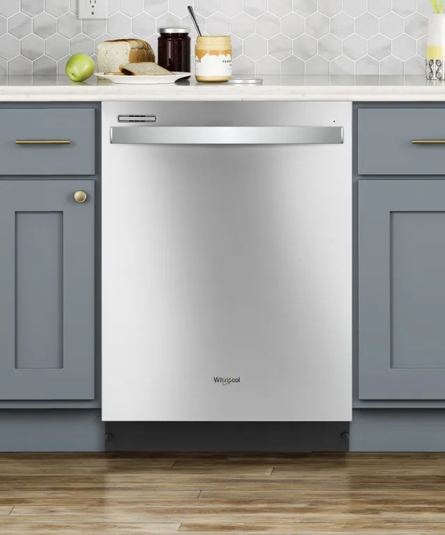 Modern kitchen counter outfitted with a built in stainless steel Whirlpool dishwasher. 
