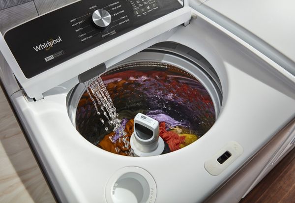An up-close look at the built-in faucet on a Whirlpool top load washer 