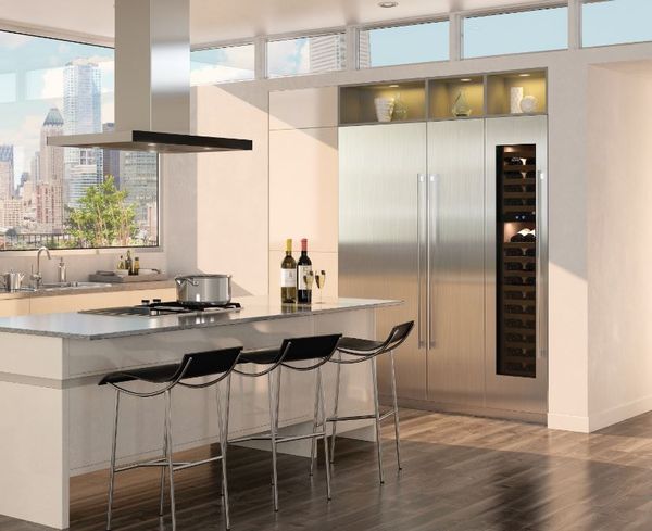A stainless steel column refrigerator and freezer in a luxury kitchen