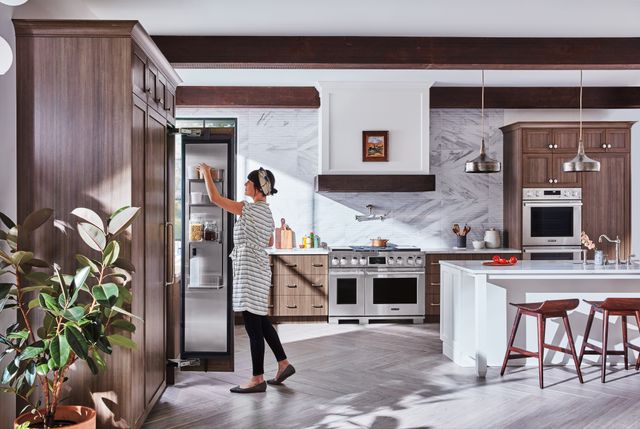woman in a kitchen with signature kitchen suite appliances