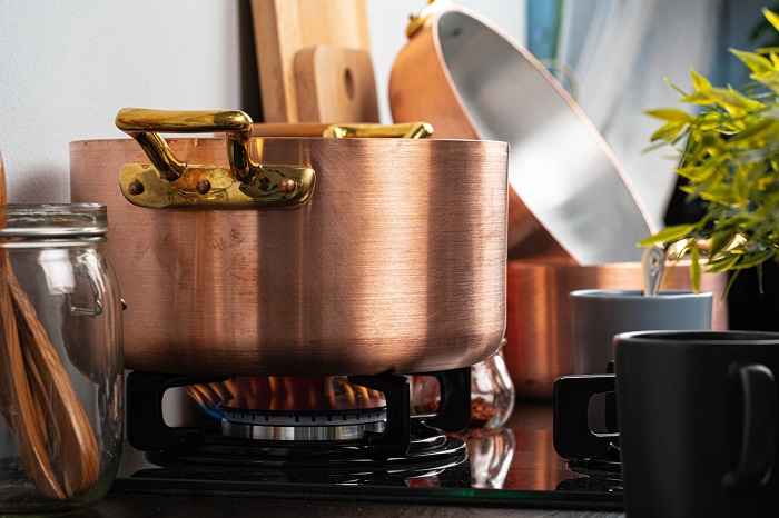 Metal pot on a gas stove burner.