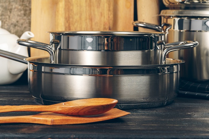 Set of stainless steel saucepans in a kitchen.