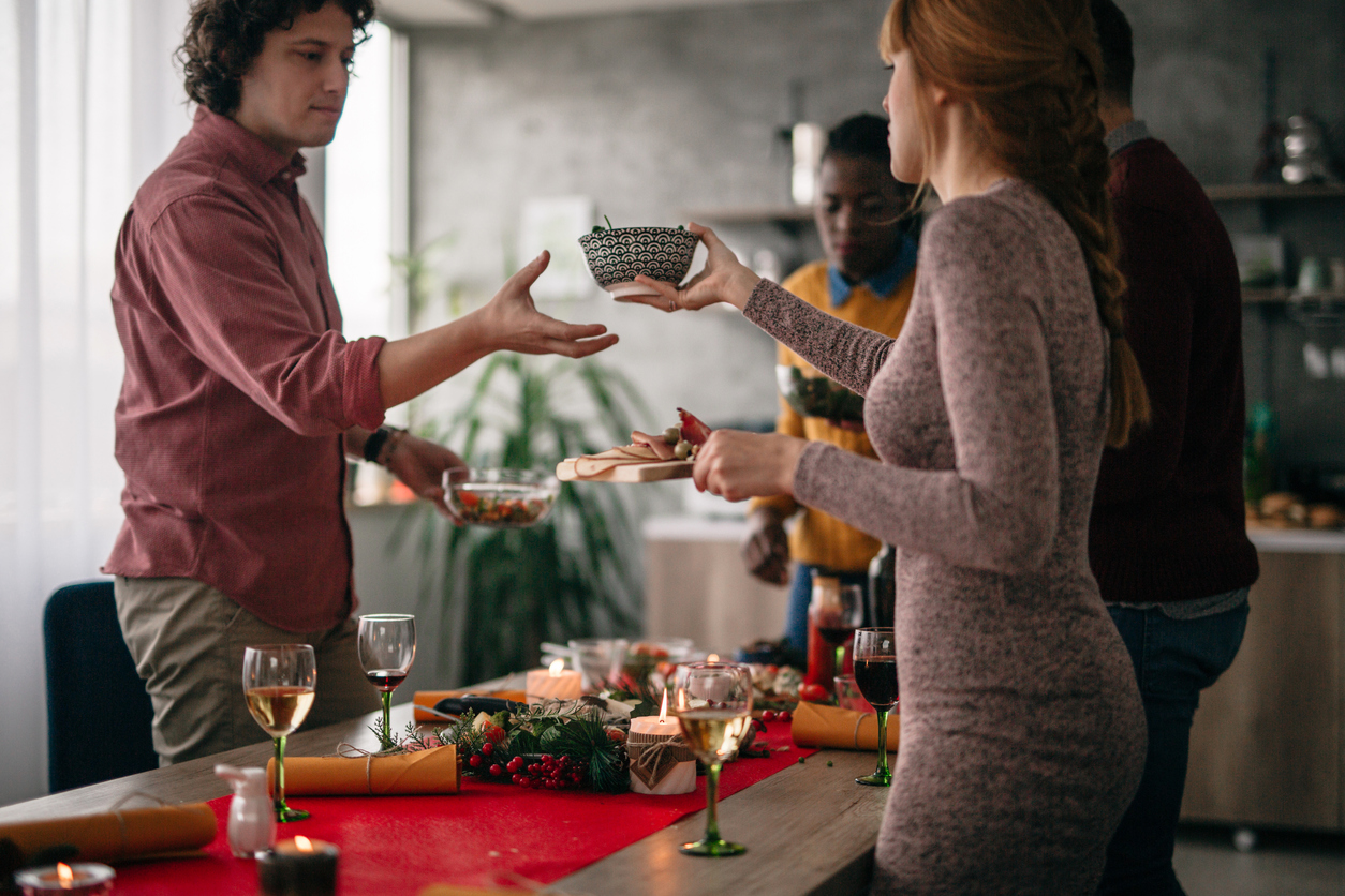four friends clean up the table after eating