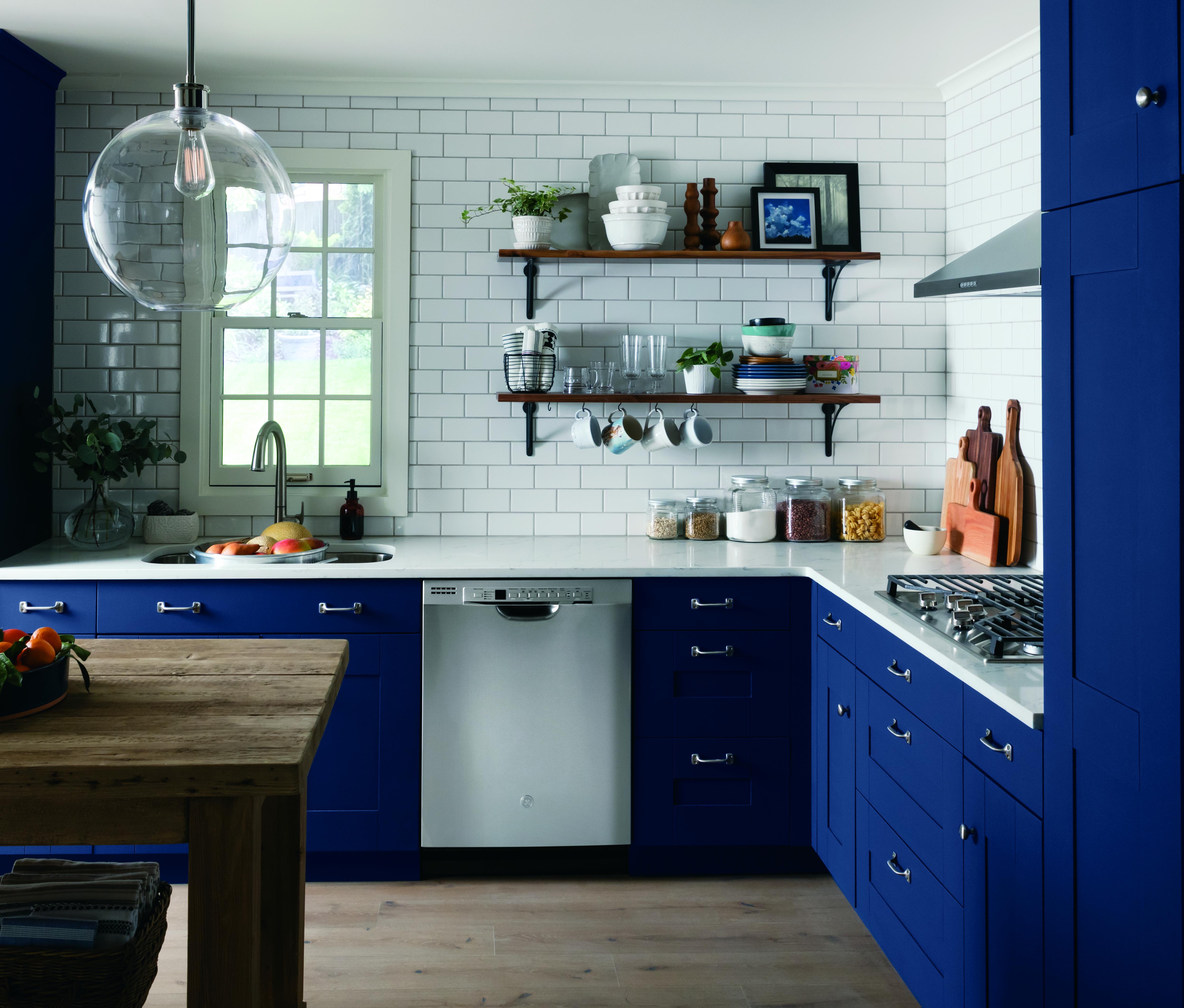 stainless-steel GE dishwasher integrated with navy-blue kitchen cabinets