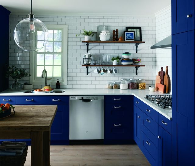front view of a modern kitchen with royal blue cabinetry and a stainless steel dishwasher