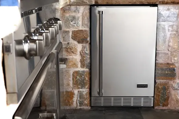 The Coyote Outdoor Living refrigerator featured in an outdoor kitchen 