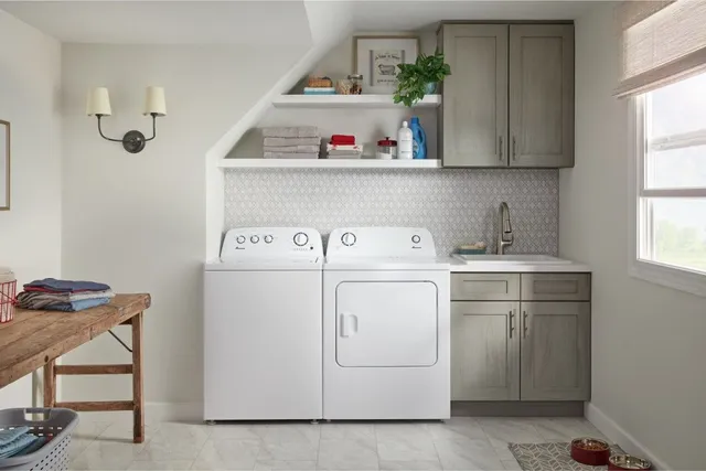 A matching Amana washer and dryer in a laundry room 