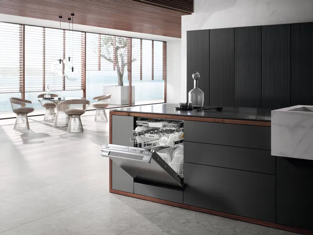 Side view of a Miele integrated dishwasher installed flush into cabinetry 