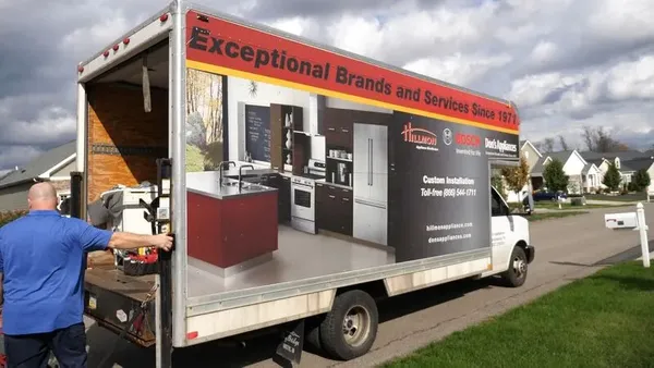 A Don’s Appliances delivery truck with an appliance tech 