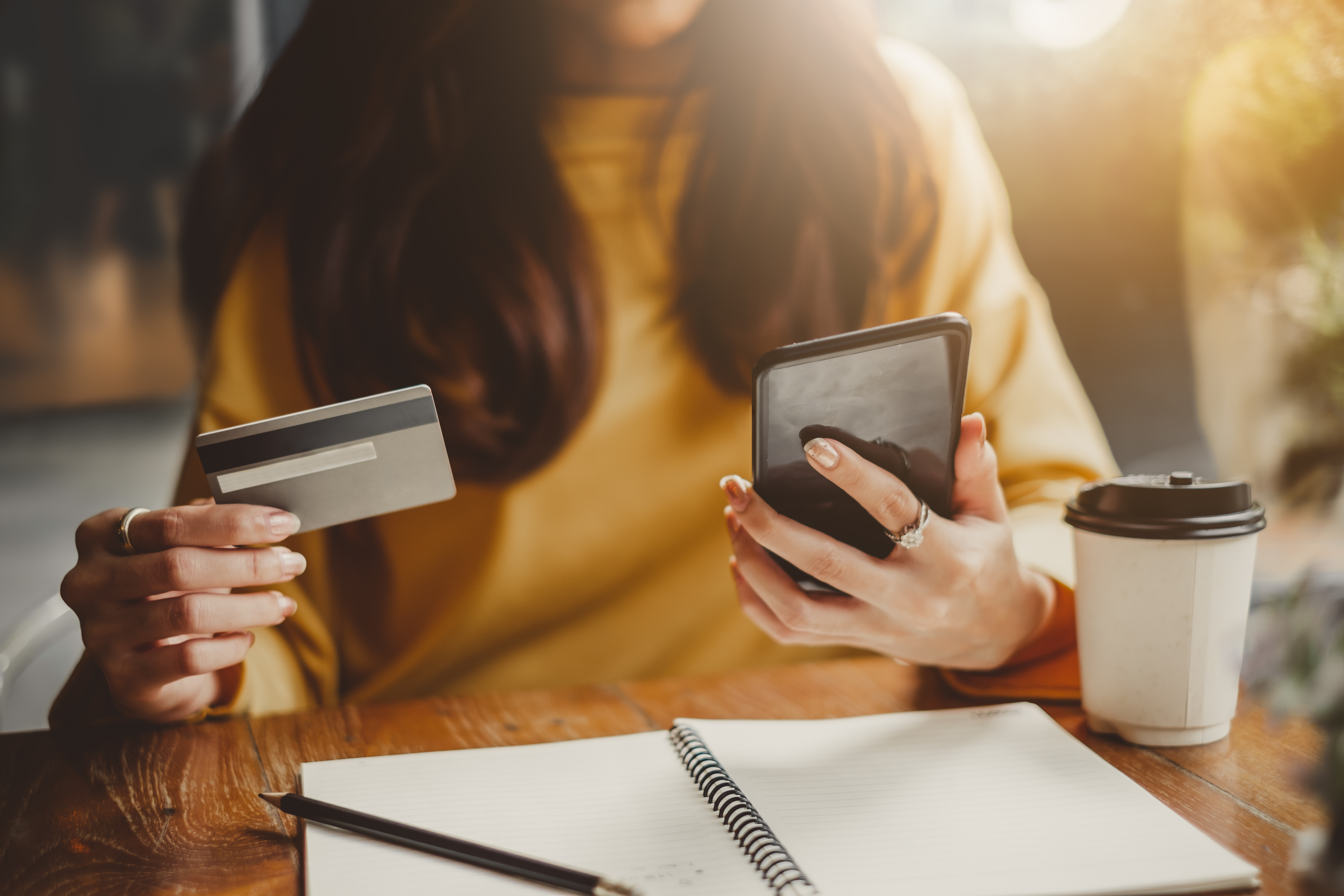 woman making payment on a cell phone