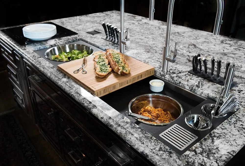A sink with a stainless steel faucet
