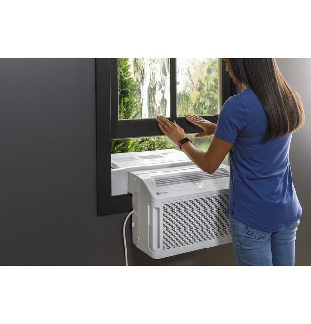 Woman installing a GE Profile window AC unit 