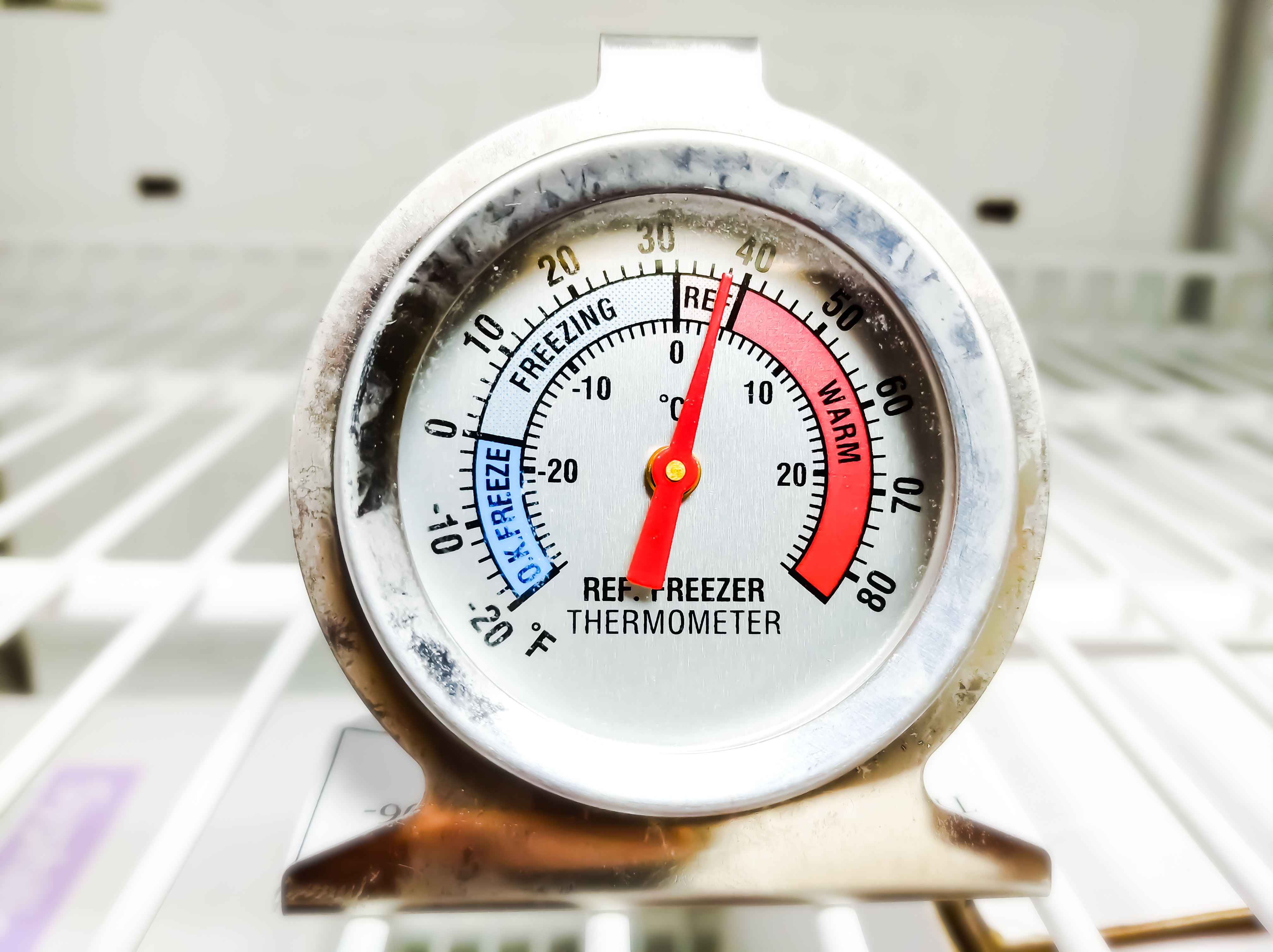 A thermostat registering warm temperatures inside a freezer 