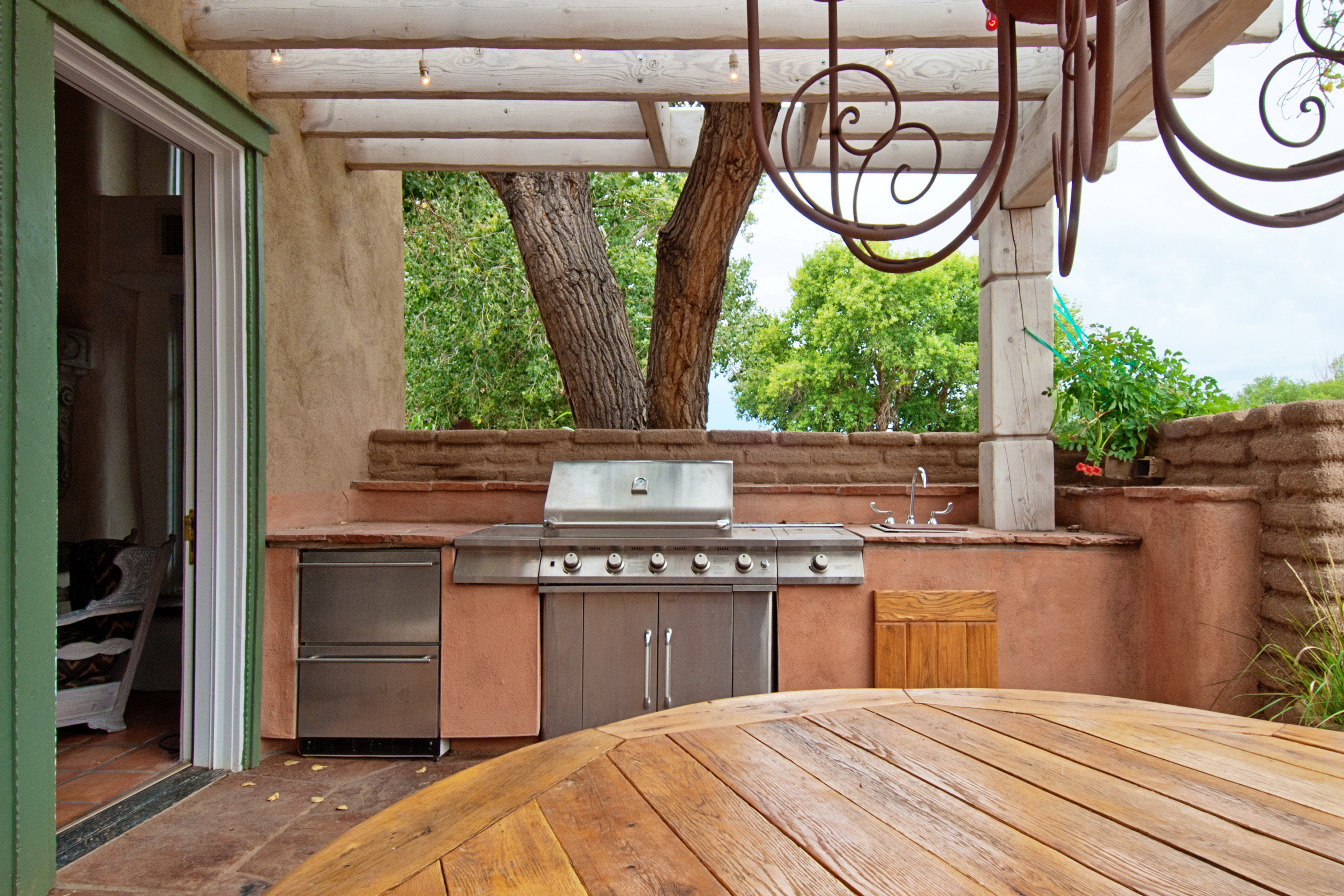 Wide shot of a built-in grill and dishwasher drawers next to a kitchen 