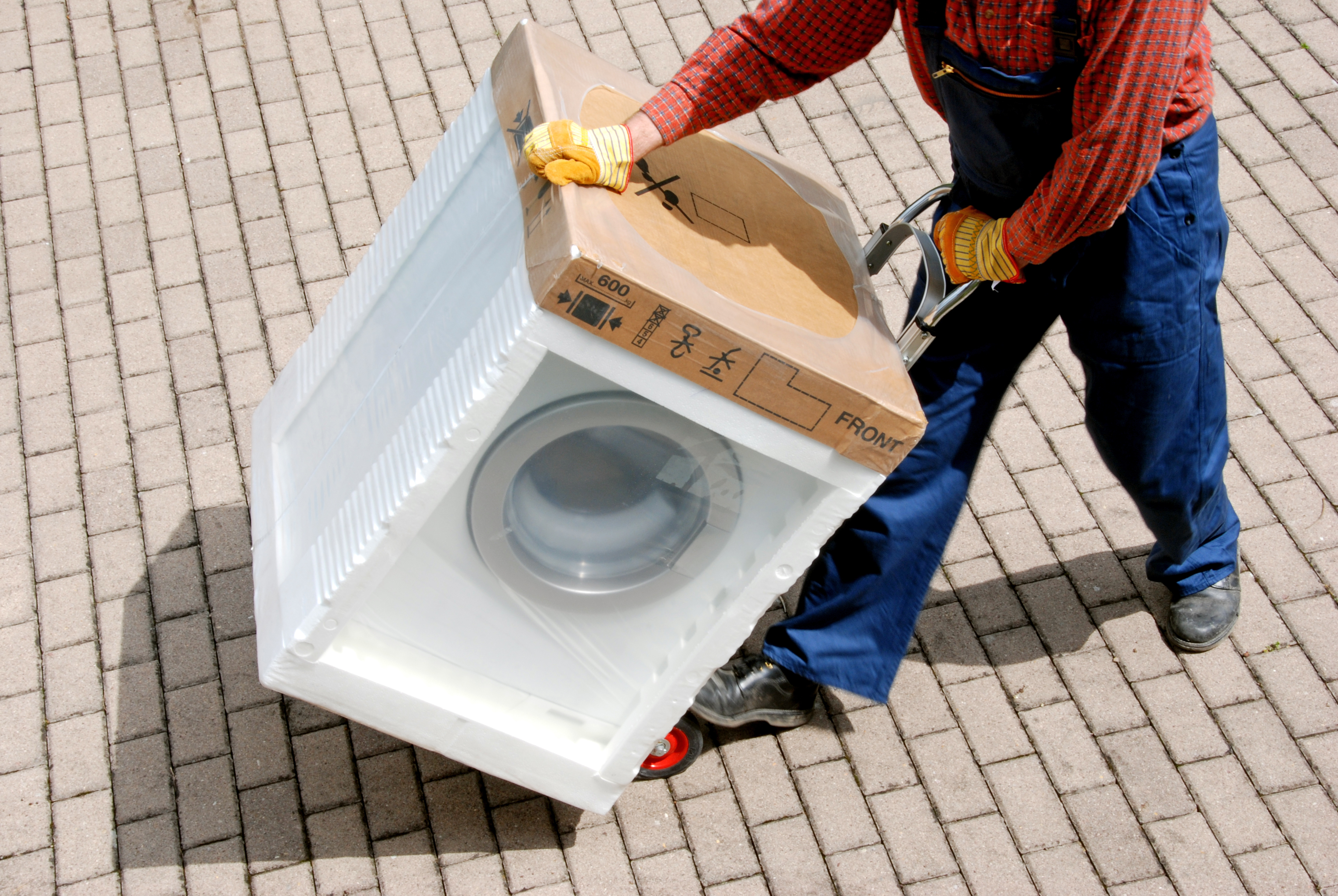Delivery ma hauling a front load washer 