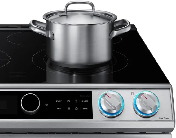 The Samsung NE63T8711SS electric range with a pot on the cooktop 
