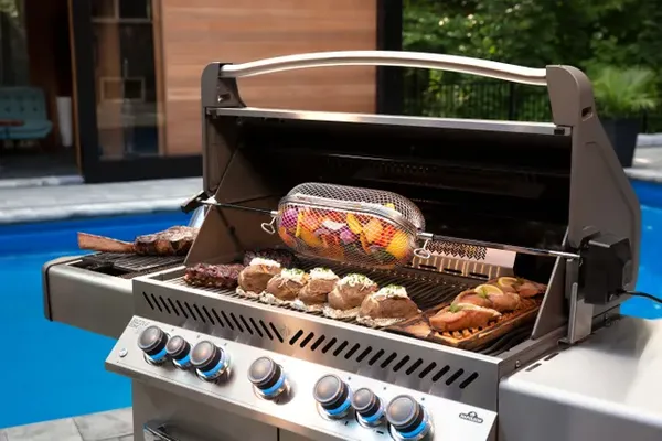 The Napoleon Prestige Series gas grill with a variety of food being grilled 