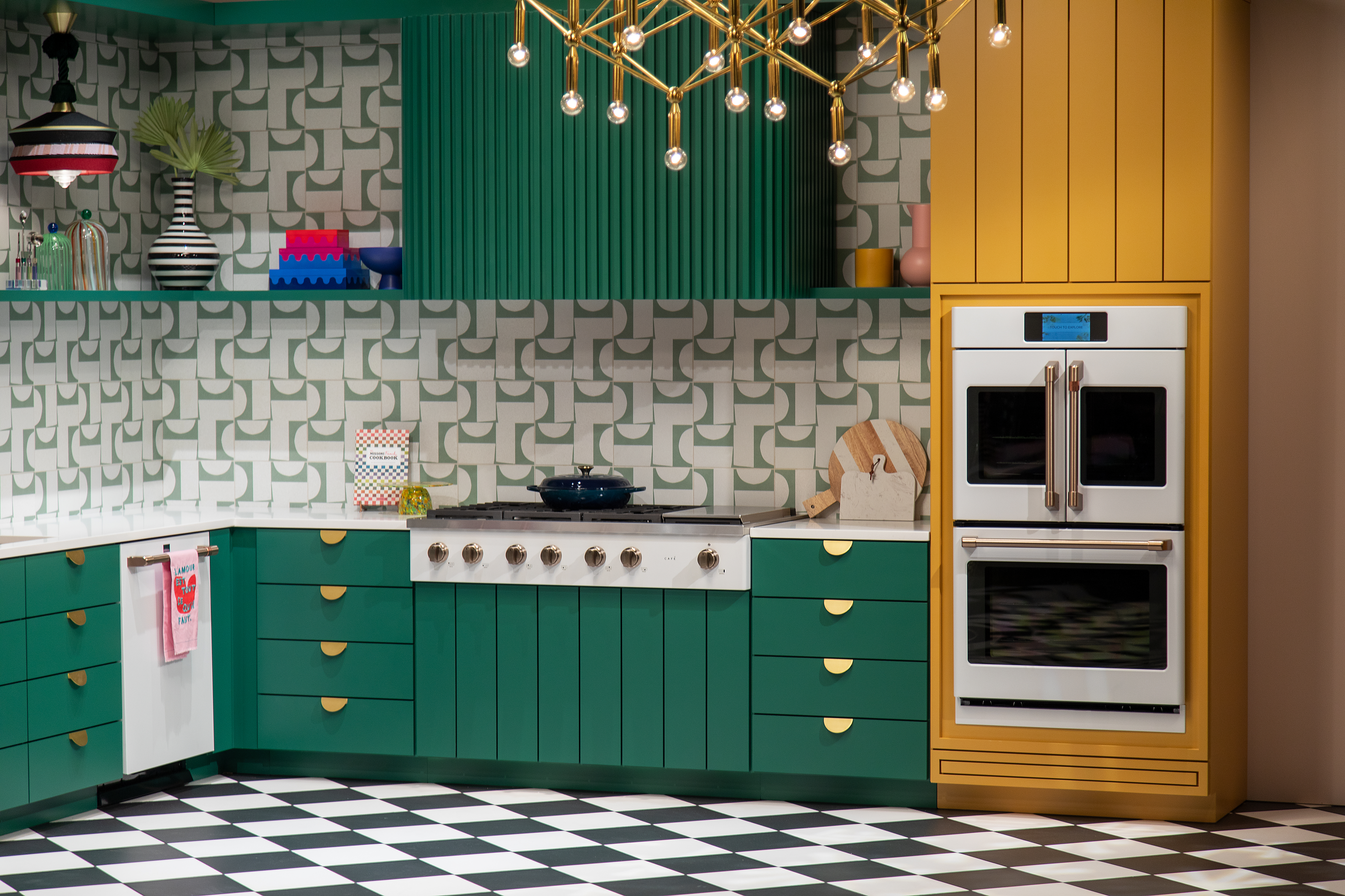 A multi-color kitchen featuring Café appliances 