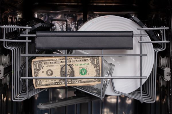 A dollar bill inside of a dishwasher 