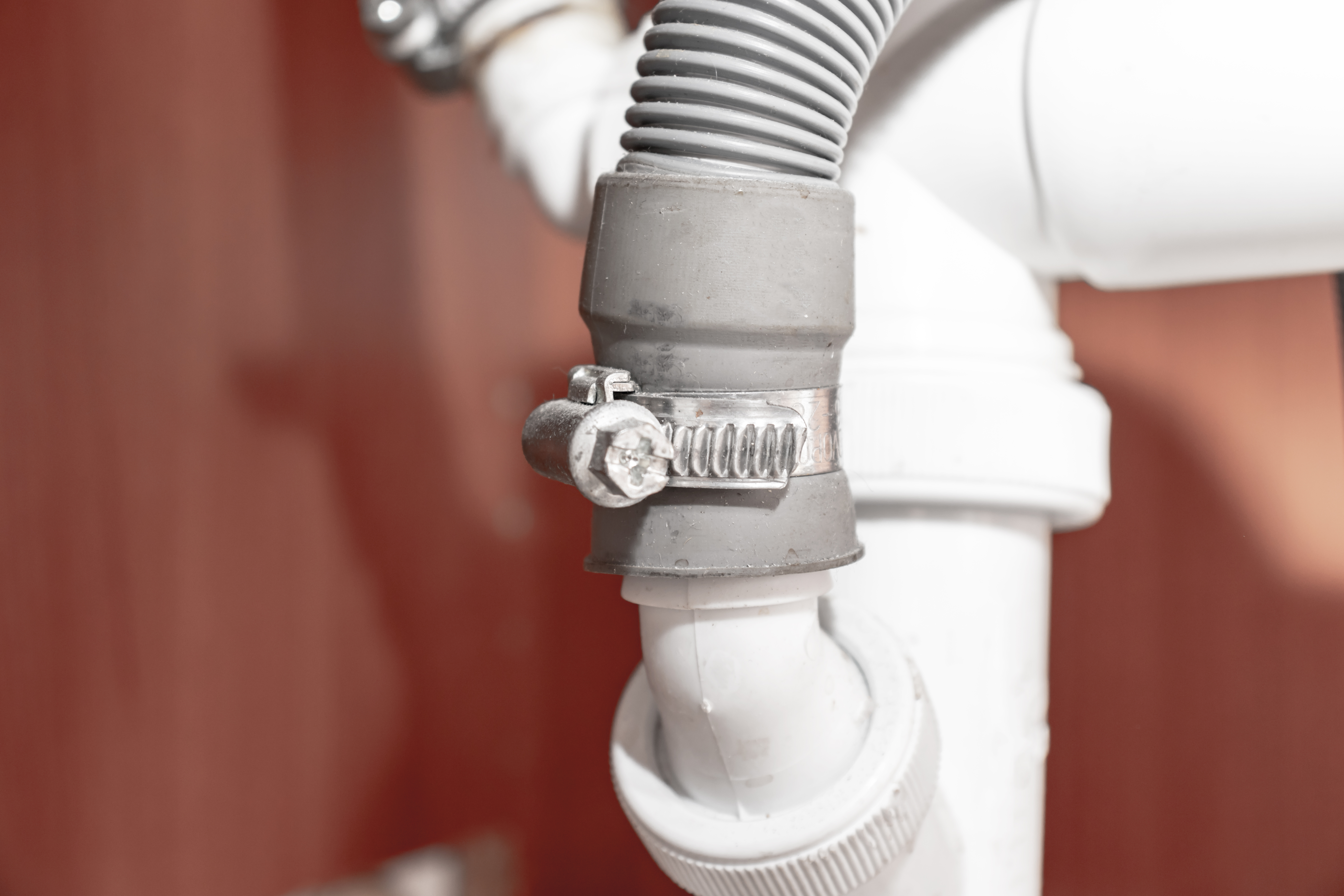 A close up of a dishwasher hose 
