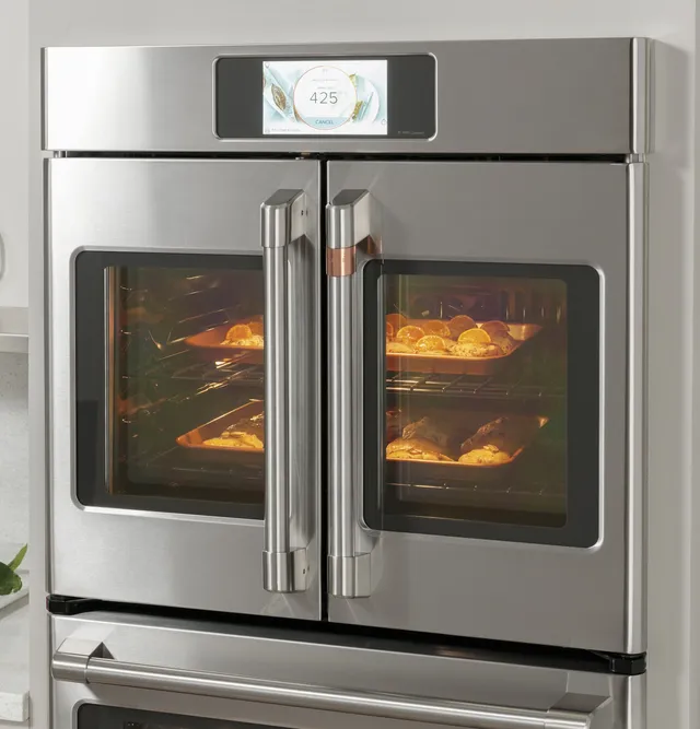 The Café CTS90FP2NS1 single French door oven shown installed in a kitchen 