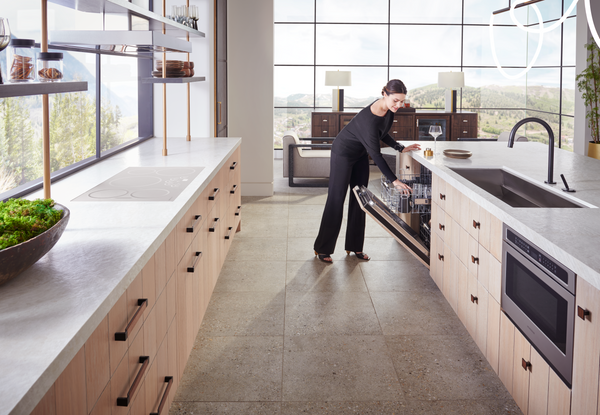 A woman in a high-end kitchen with Monogram appliances 