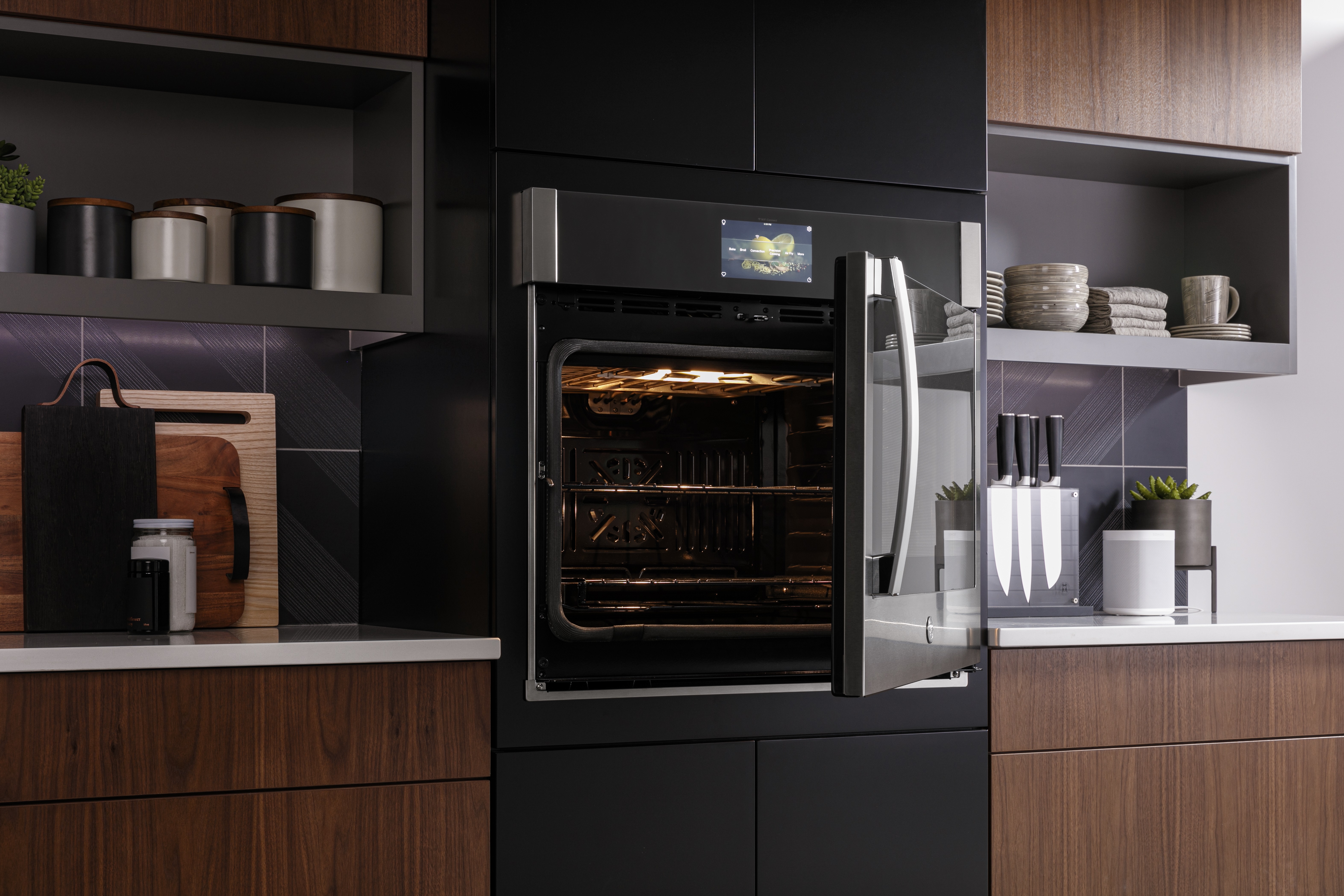 A GE Profile side-swing wall oven with its door open 