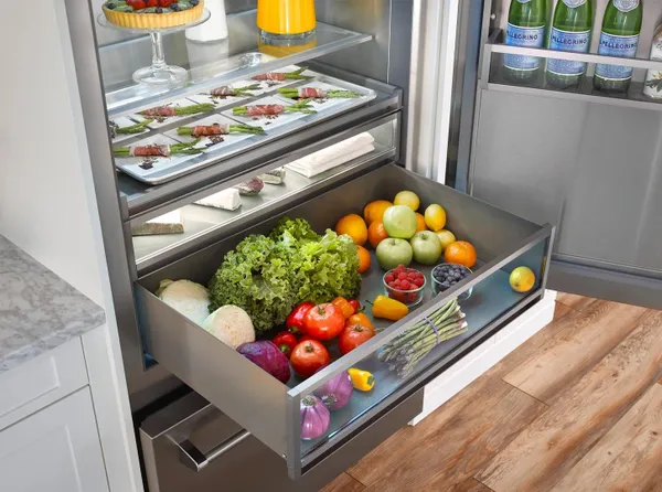 The BlueStar BBB36R2 featured with its doors and drawer open stocked with fresh produce 