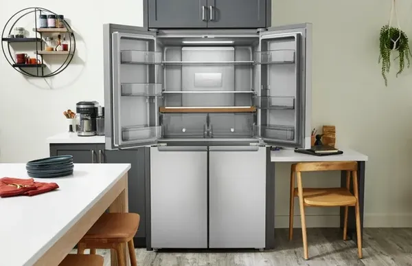 The KitchenAid KRQC506MPS French door refrigerator with its doors open in a modern kitchen 