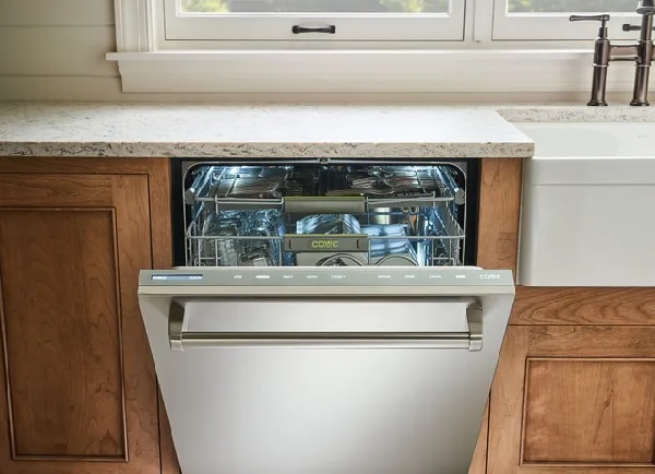 A Cove dishwasher with its door open in a farmhouse kitchen 
