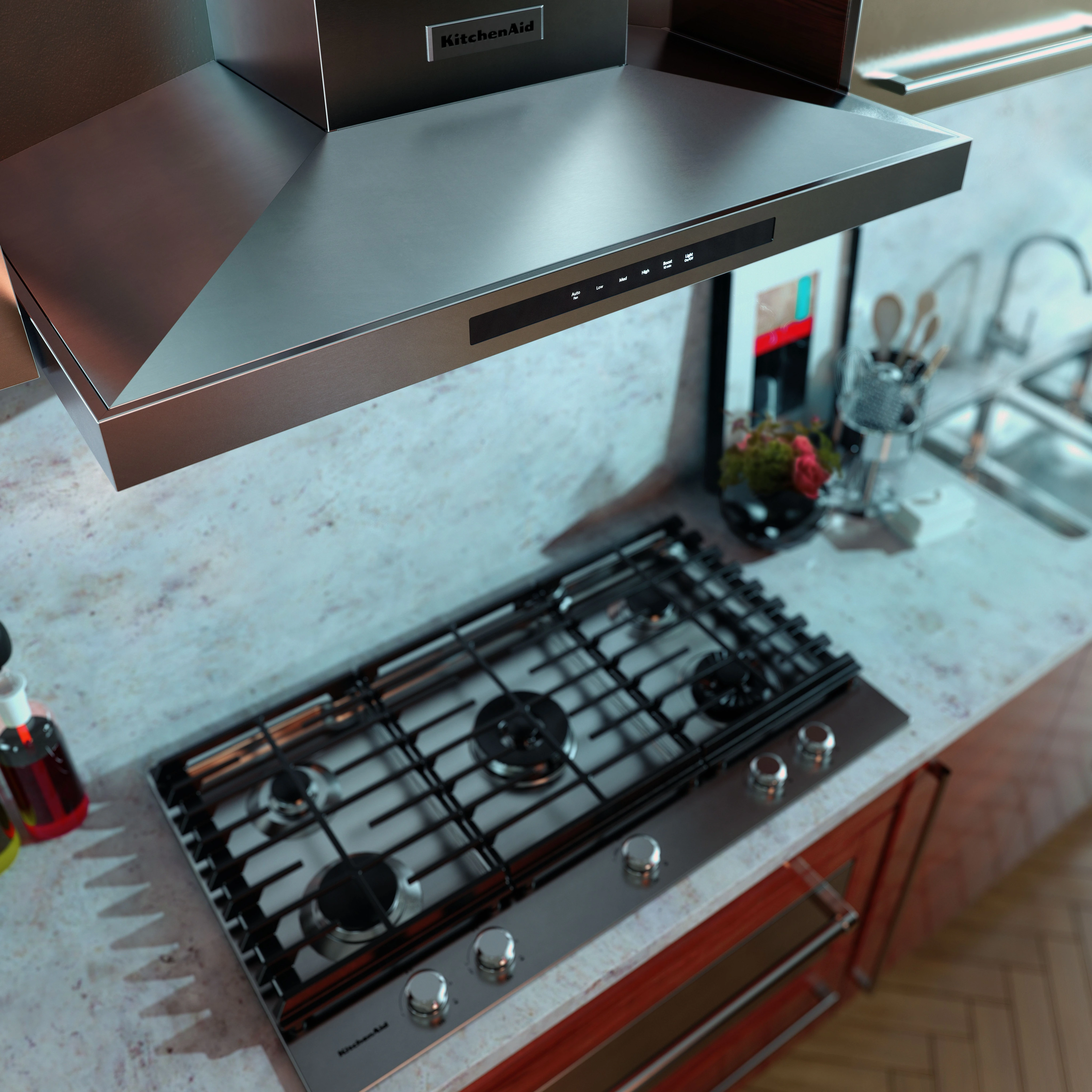 The KitchenAid KVWB606DSS wall mount hood above a cooktop 