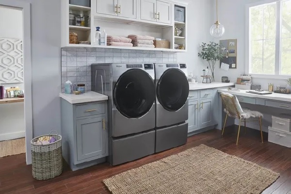 The Whirlpool WFW6605MC and WED6605MC front load washer and dryer pair in a laundry room 