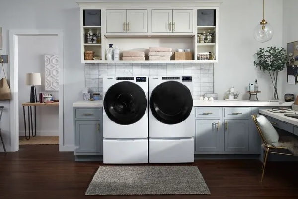 A matching Whirlpool front load washer and dryer in a modern laundry room 