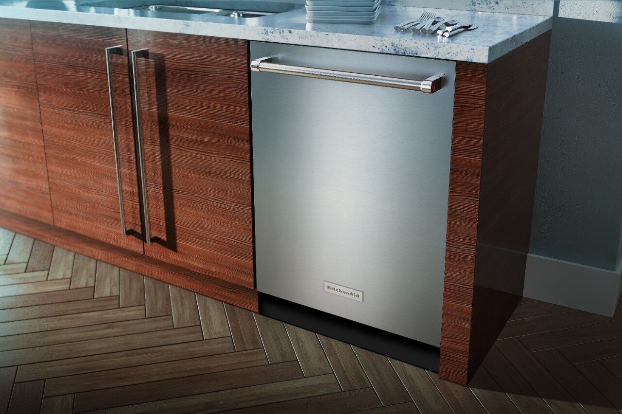 A KitchenAid stainless steel dishwasher installed in wooden cabinetry 
