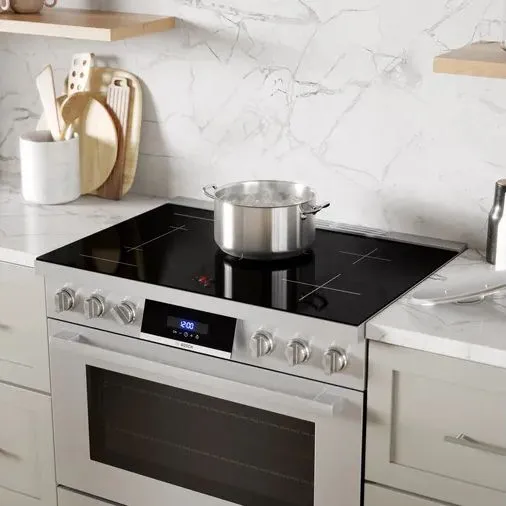 The Bosch 800 Series HIS8655U 36” induction range with a pot on its cooktop