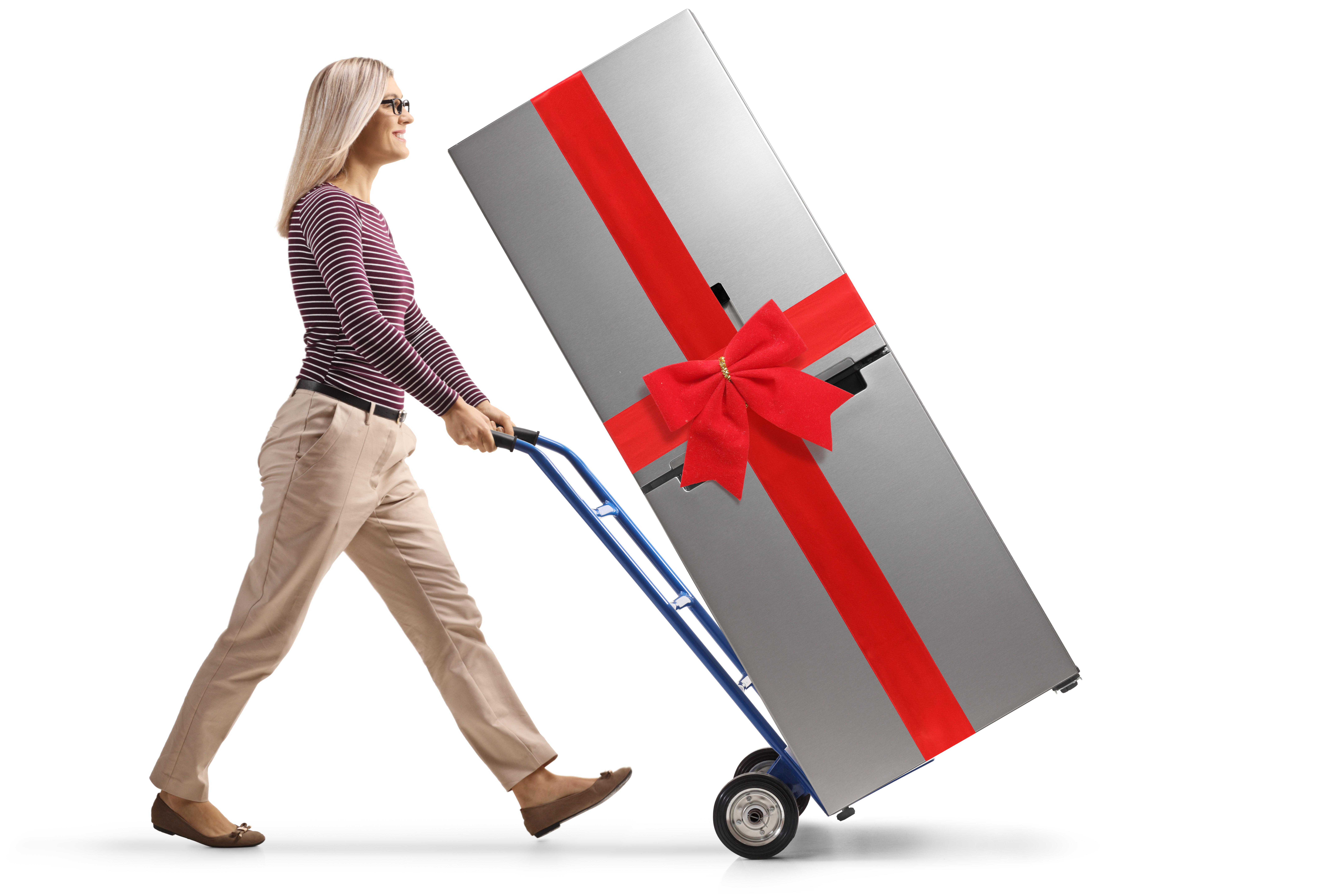 A woman hauling a refrigerator with a bow on a hand truck 