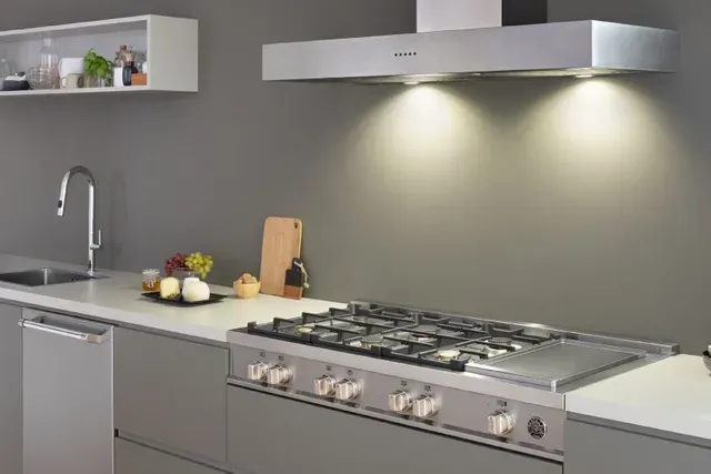 front view of a modern kitchen with a bertazzoni range and broan range hood