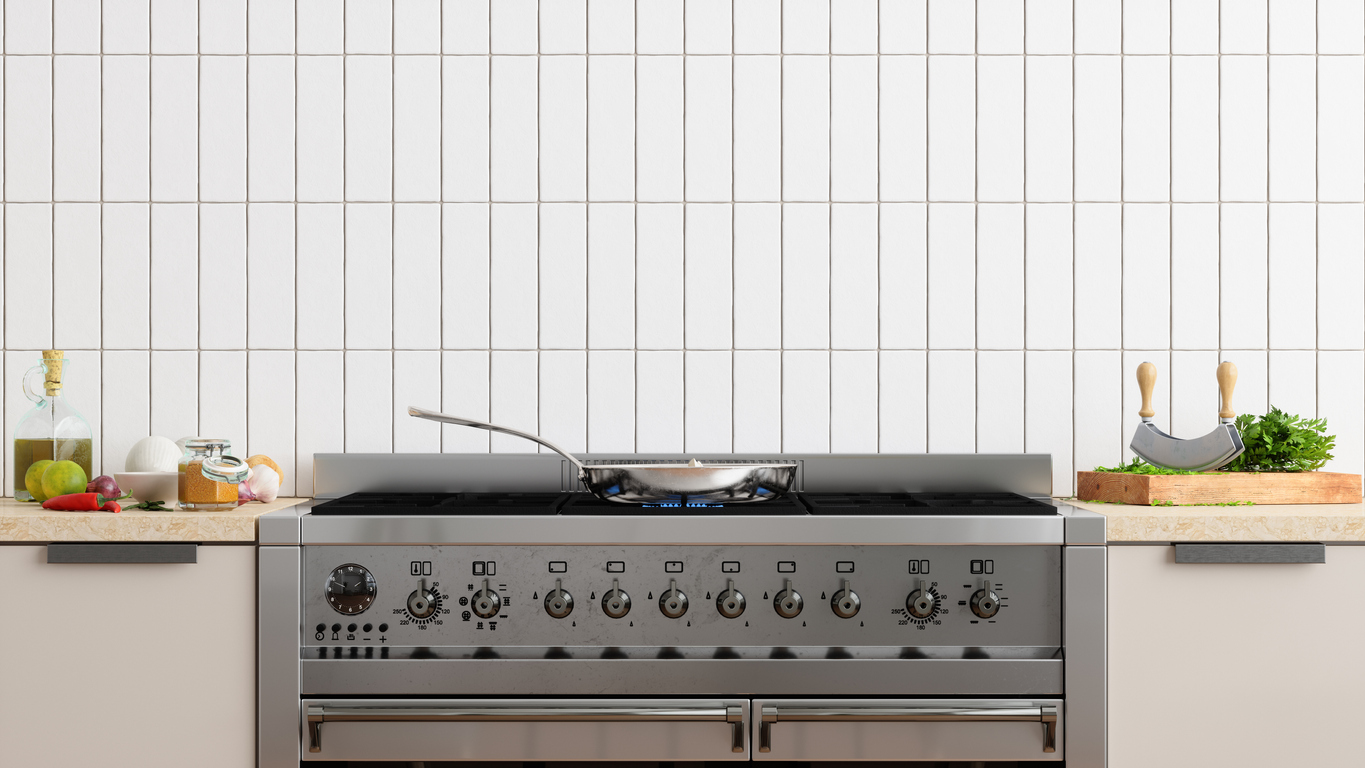  Front View Of Burning Kitchen range With Cooking Pan.