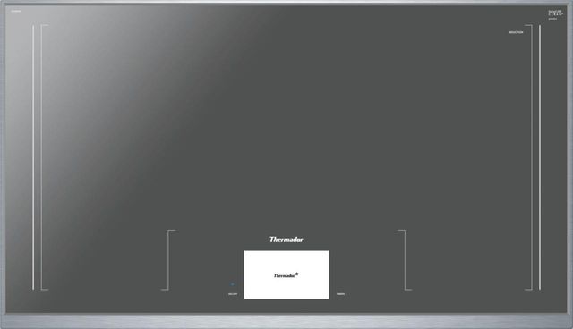 Stock photo of a silver Thermador brand induction cooktop with one central burner.