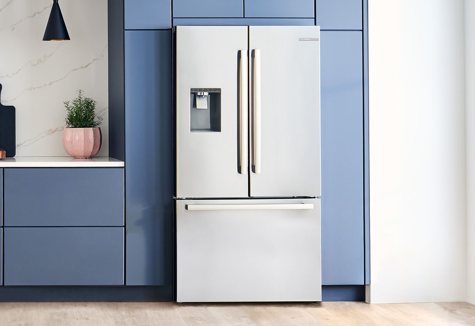 A Bosch French door refrigerator shown in a blue-themed kitchen