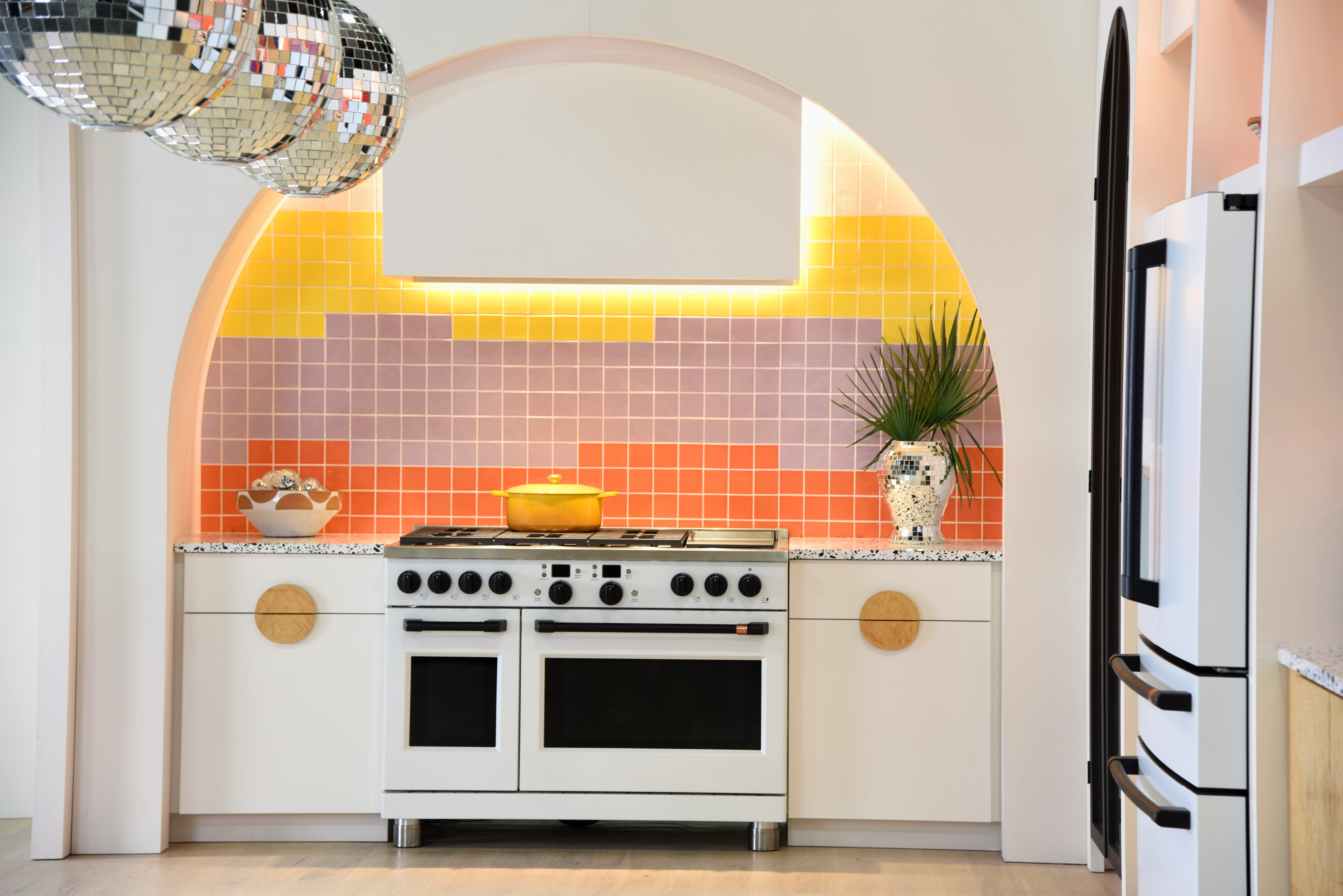 A Café matte-white 48” range in ai muti-colored kitchen 