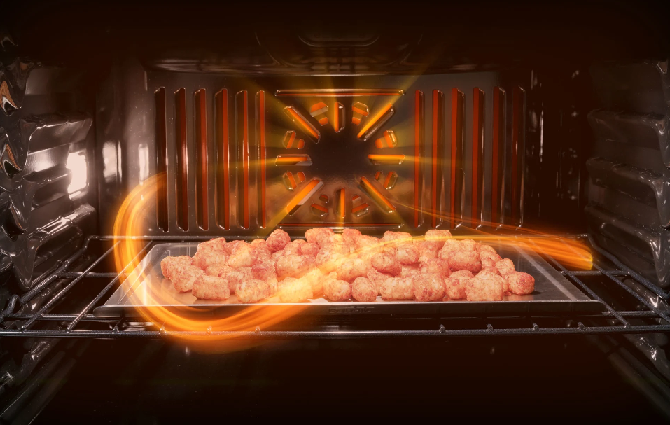 Tater tots baking inside a GE Profile convection oven 