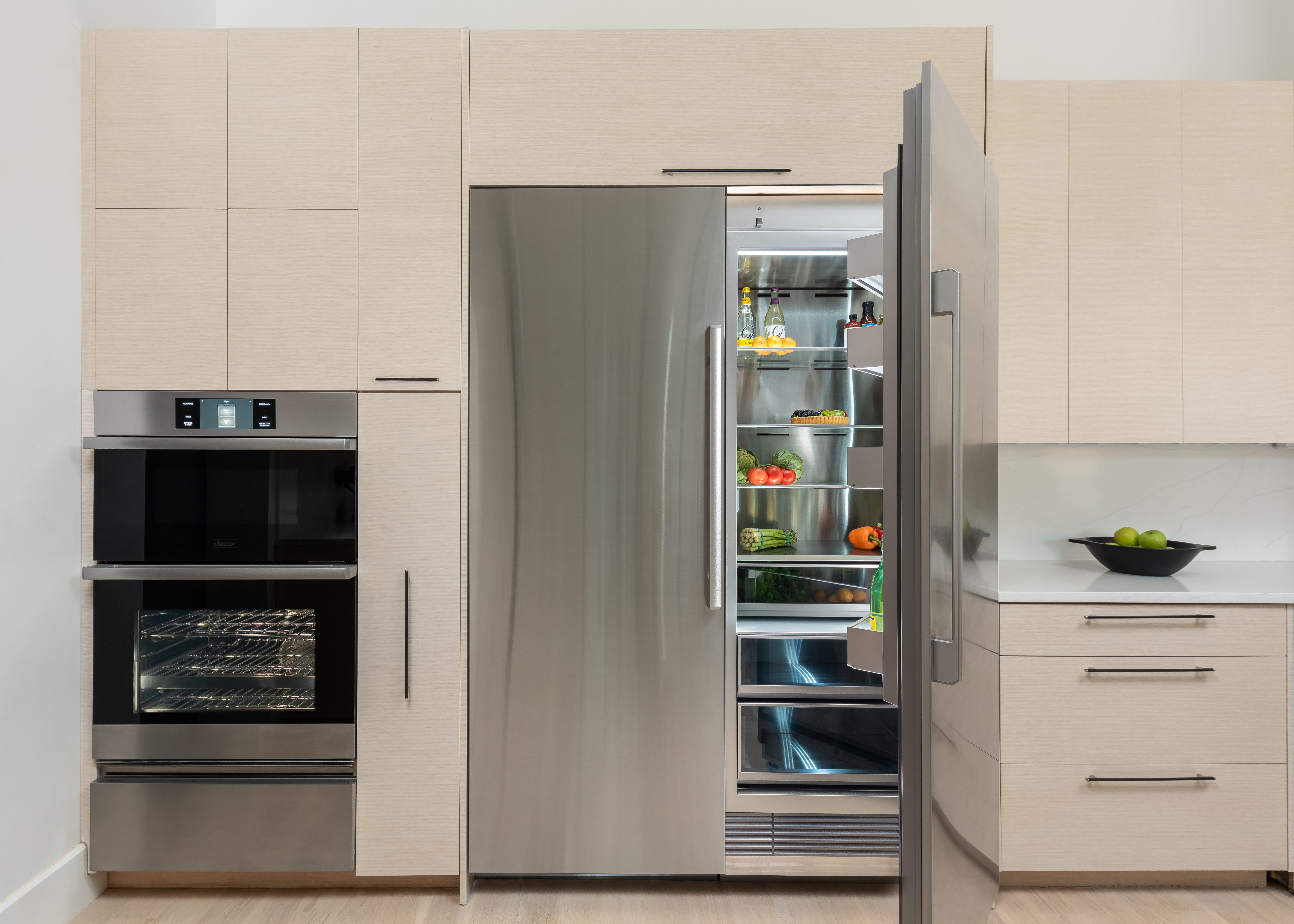 A Dacor column refrigerator and freezer stocked with fresh produce 