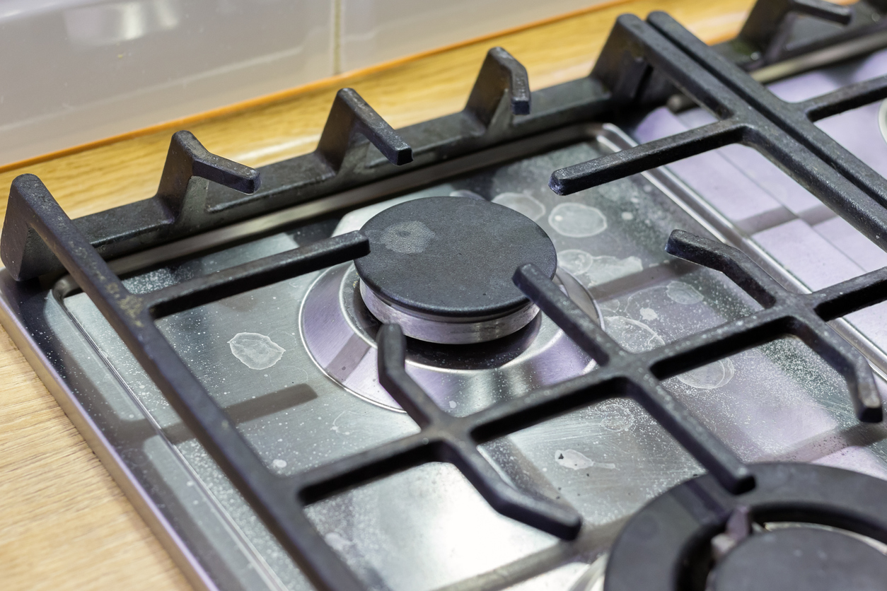 dried water marks on a stainless steel gas cooktop