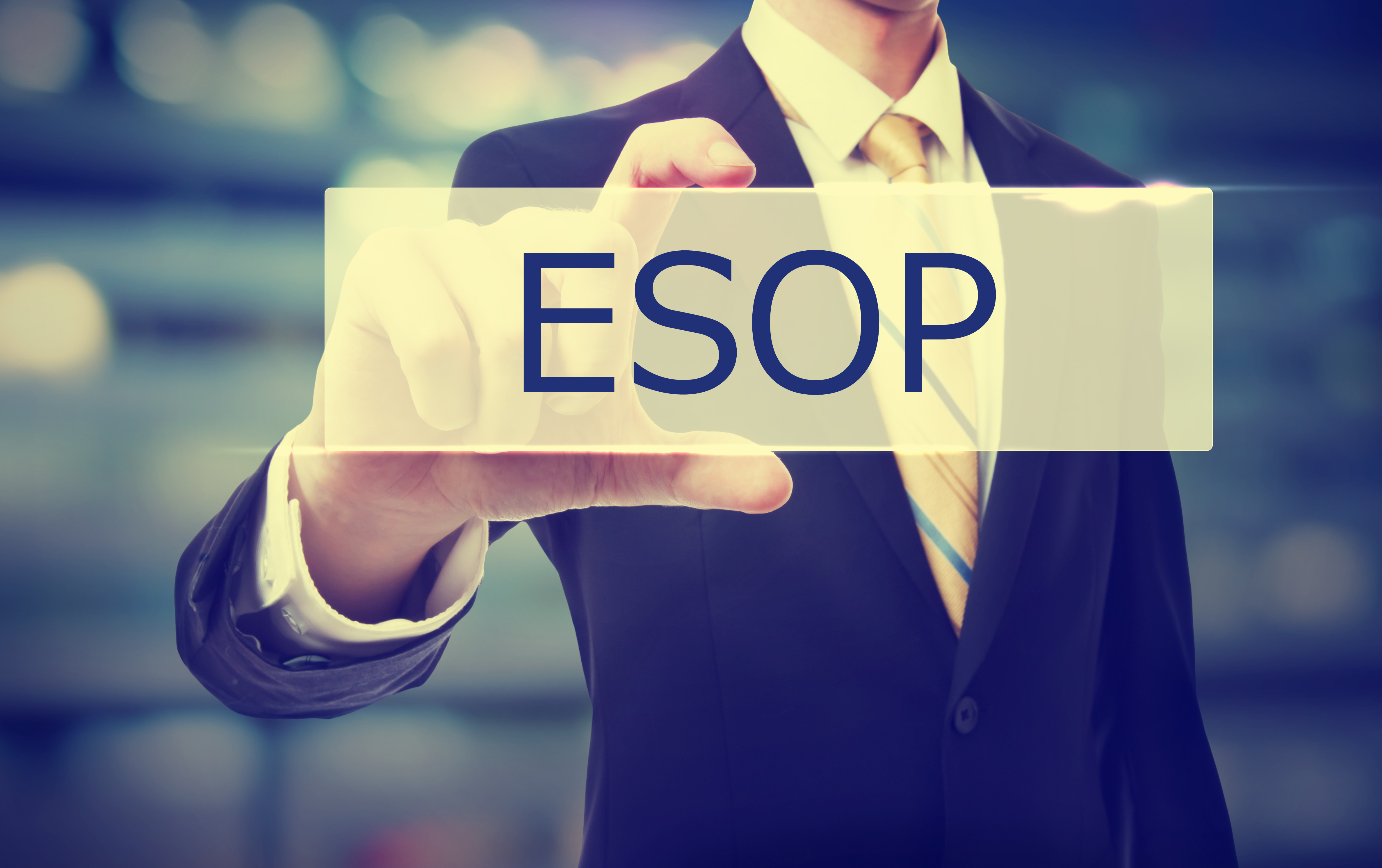 A man holding a graphic saying ESOP 