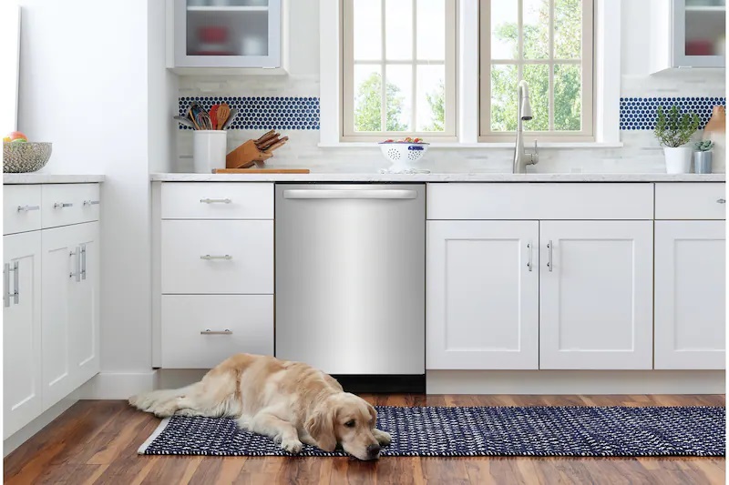 white kitchen with dog laying in front of Frigidaire dishwasher