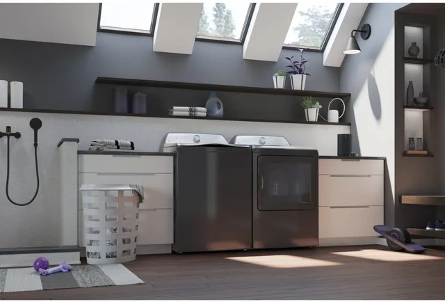 A GE Profile washer and dryer pair in a laundry room 