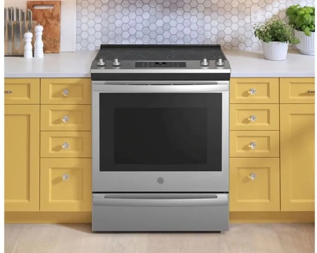 The GE JS760SPSS 30” electric range installed into yellow kitchen cabinets 
