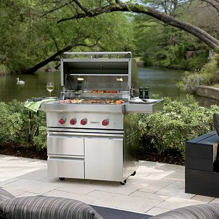 The Wolf OG36-LP 36” built-in gas grill shown outdoors next to a river 